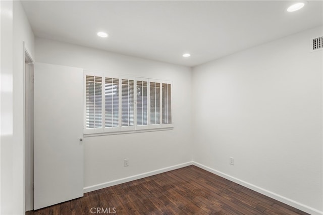 unfurnished room featuring dark hardwood / wood-style floors