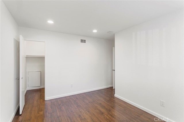 spare room with dark hardwood / wood-style flooring