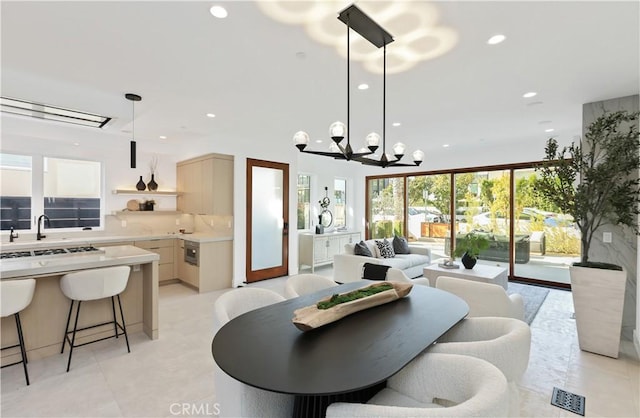 dining space with an inviting chandelier and sink