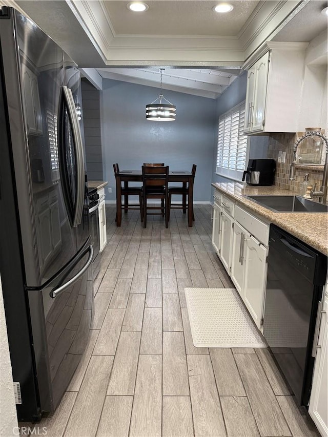 kitchen with a sink, white cabinetry, backsplash, wood tiled floor, and black appliances