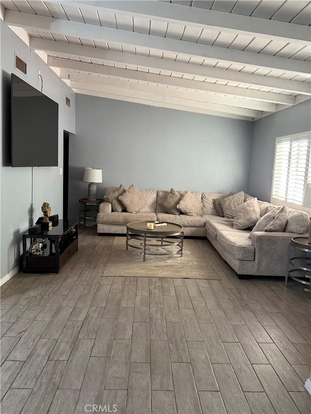 living area with vaulted ceiling with beams, wood tiled floor, visible vents, and baseboards