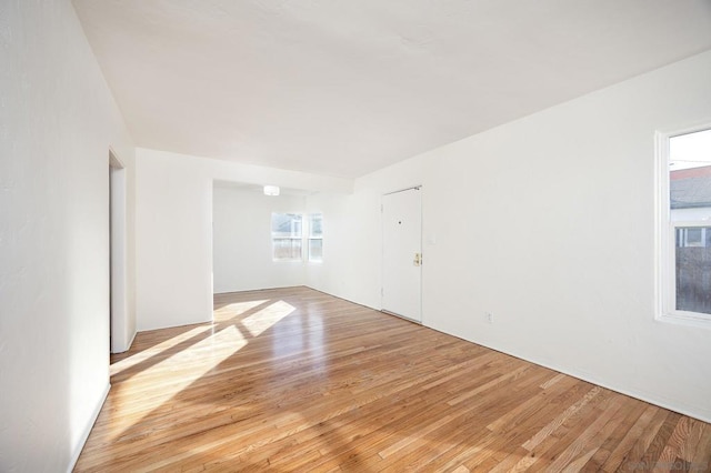 empty room featuring a healthy amount of sunlight and light wood-type flooring