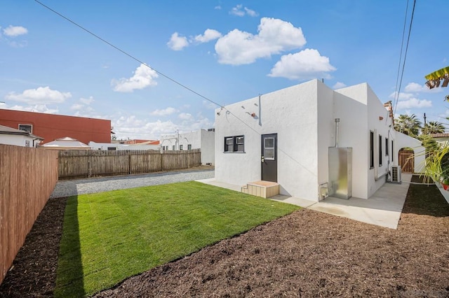 rear view of property featuring a yard and a patio