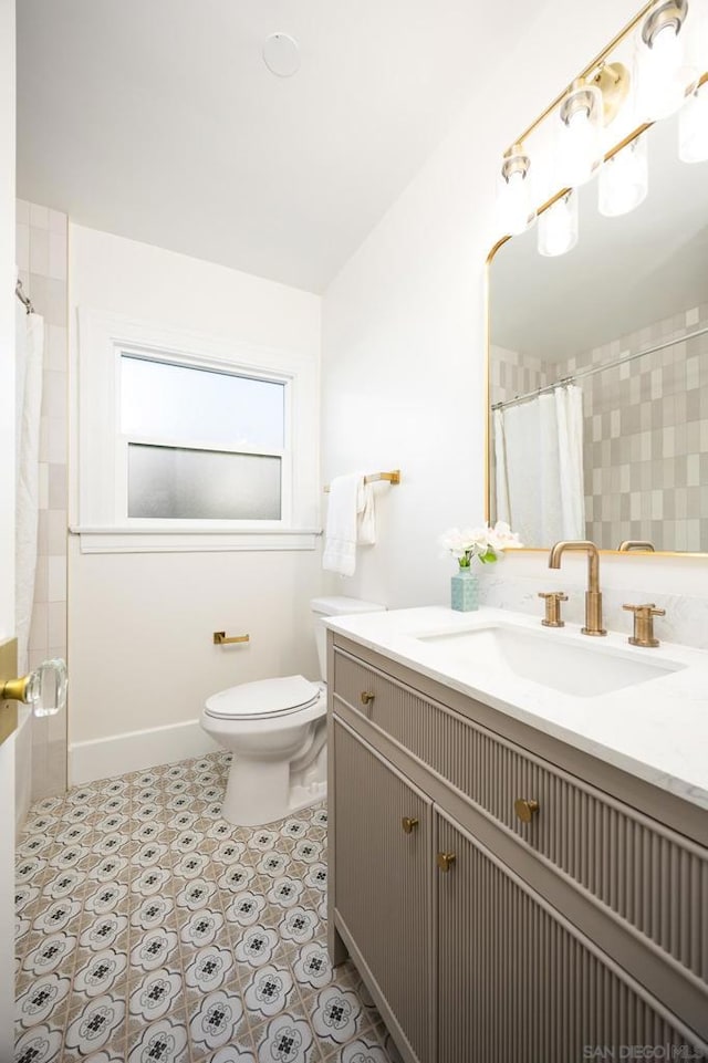 bathroom featuring vanity, toilet, tile patterned flooring, and a shower with shower curtain