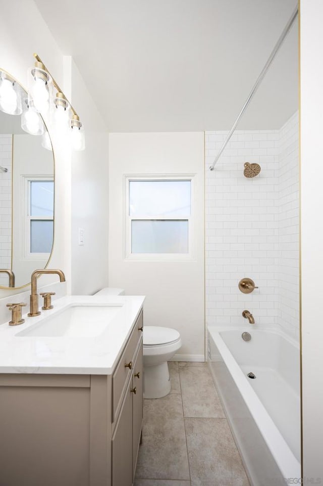 full bathroom featuring tiled shower / bath combo, vanity, tile patterned floors, and toilet