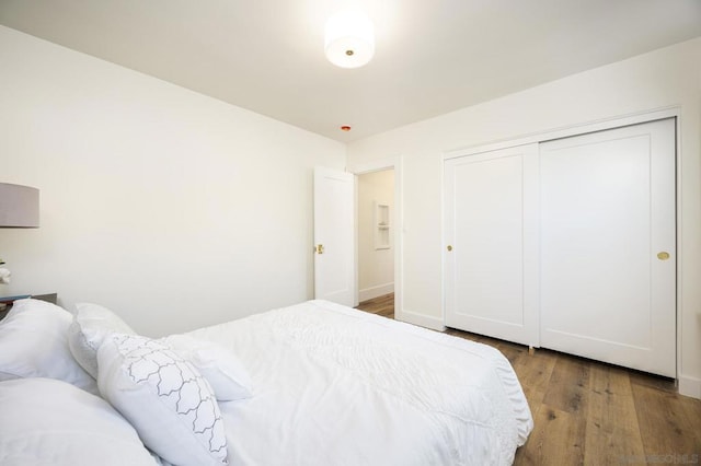 bedroom featuring hardwood / wood-style floors and a closet