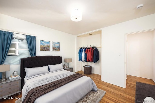 bedroom featuring wood-type flooring and a closet