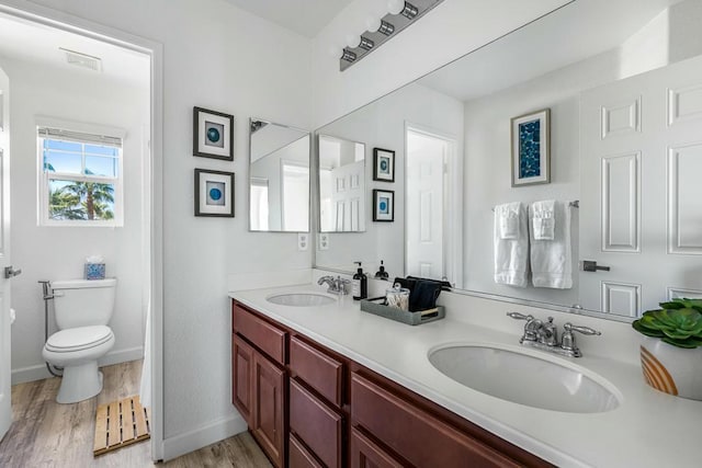 bathroom with vanity, hardwood / wood-style flooring, and toilet