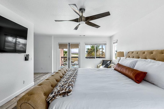 bedroom with ceiling fan, access to exterior, a textured ceiling, and light wood-type flooring