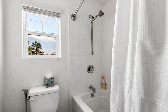 bathroom with toilet and shower / bath combo