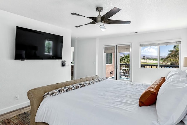 bedroom featuring hardwood / wood-style floors, access to exterior, and ceiling fan