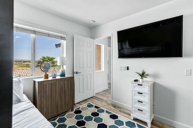 bedroom with light wood-type flooring