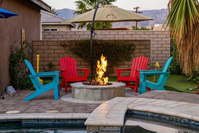 view of patio / terrace featuring a mountain view and a fire pit