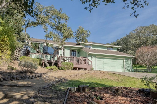 view of front facade featuring a wooden deck and a garage