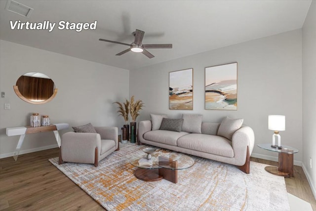 living room with ceiling fan and hardwood / wood-style floors