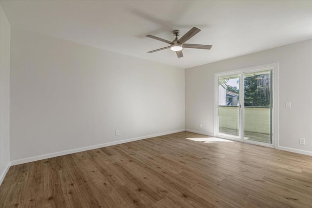 empty room with ceiling fan and light wood-type flooring