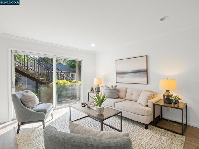 living room featuring crown molding and light hardwood / wood-style floors