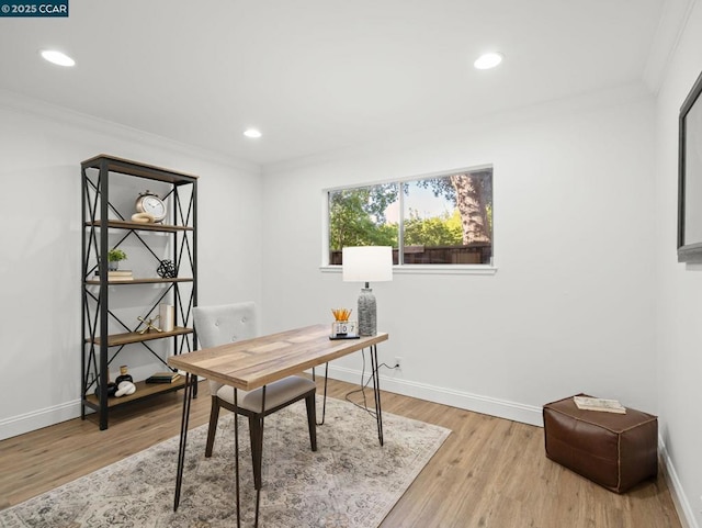 office space featuring ornamental molding and light hardwood / wood-style floors