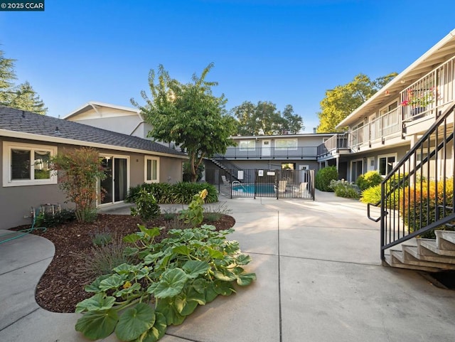 surrounding community featuring a swimming pool and a patio area