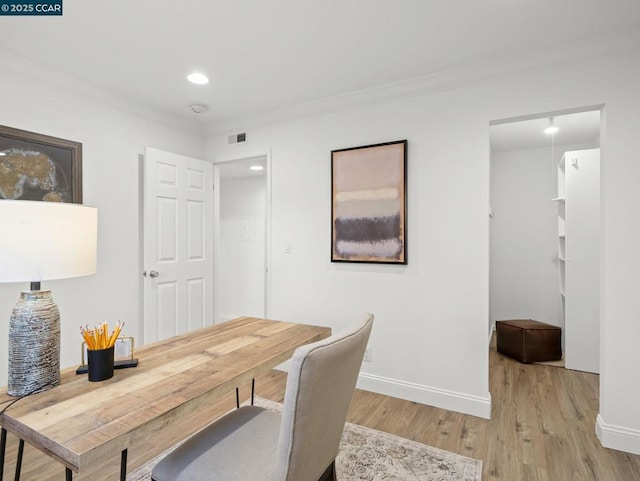 office space featuring ornamental molding and light hardwood / wood-style floors