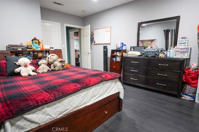 bedroom with dark hardwood / wood-style floors