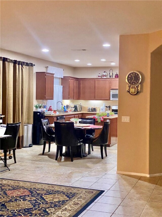 tiled dining space featuring sink