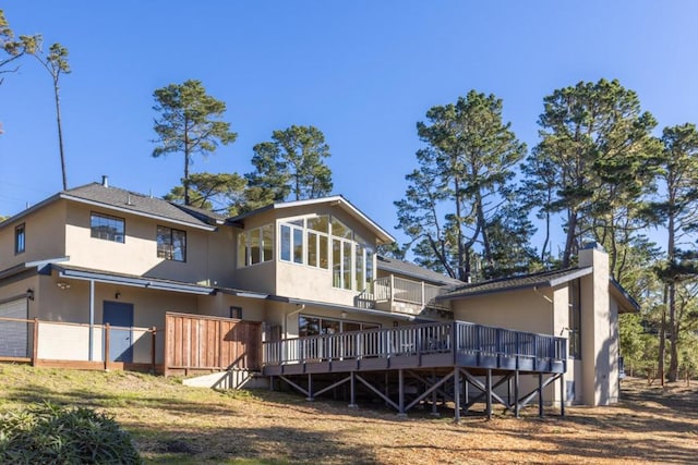 back of property featuring a wooden deck