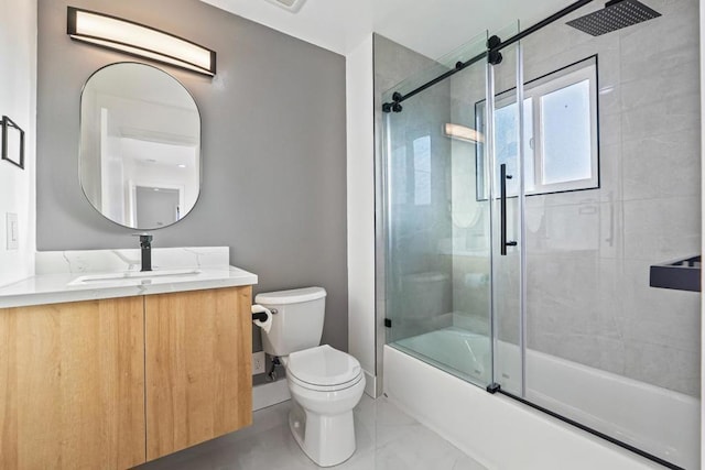 full bathroom featuring bath / shower combo with glass door, vanity, and toilet