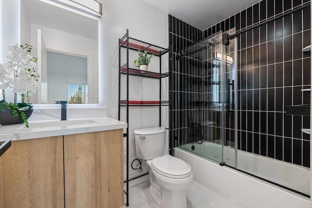 full bathroom with vanity, shower / bath combination with glass door, and toilet