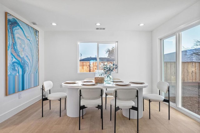 dining space featuring plenty of natural light and light wood-type flooring