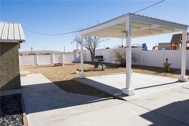 view of patio with a fenced backyard and a grill