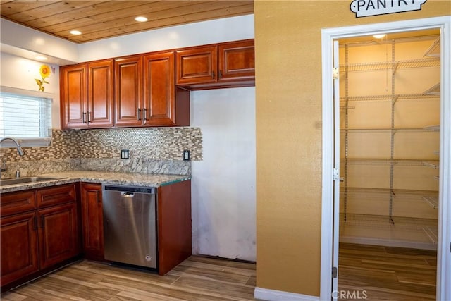 kitchen with sink, light hardwood / wood-style flooring, tasteful backsplash, light stone countertops, and stainless steel dishwasher