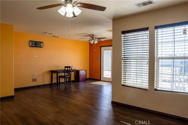 interior space featuring baseboards, visible vents, and dark wood-style flooring