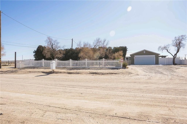 view of yard featuring a garage and a fenced front yard