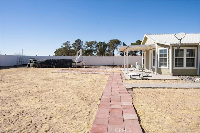 view of yard featuring a patio area and a fenced backyard