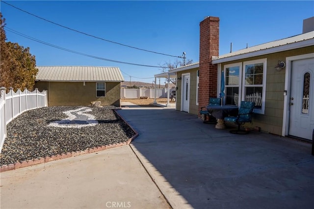 exterior space with driveway, an outdoor structure, and fence