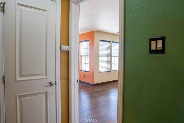 hall featuring dark wood finished floors and baseboards