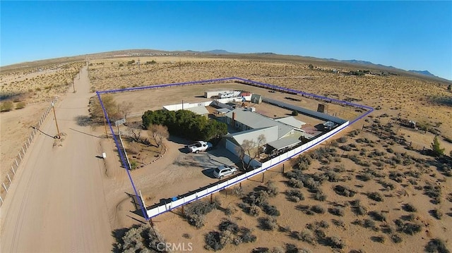 aerial view featuring a rural view, a desert view, and a mountain view