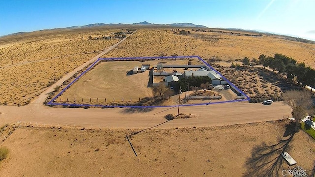 birds eye view of property with view of desert, a rural view, and a mountain view