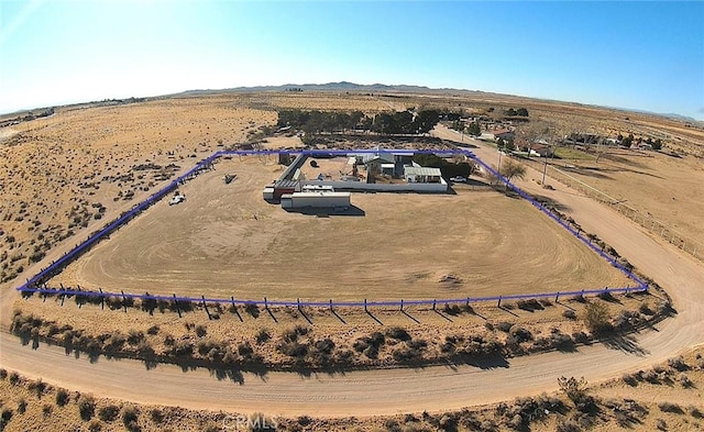 birds eye view of property with view of desert, a rural view, and a mountain view