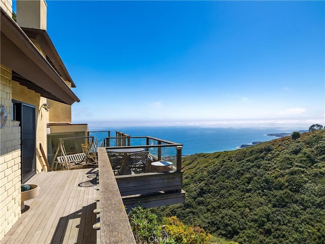 wooden deck featuring a water view