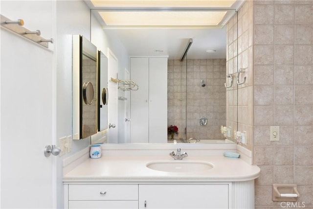 bathroom featuring tile walls and vanity