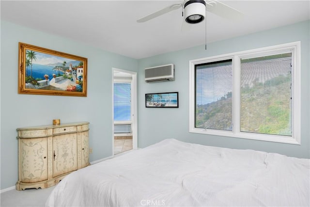 carpeted bedroom with a wall mounted AC and ceiling fan