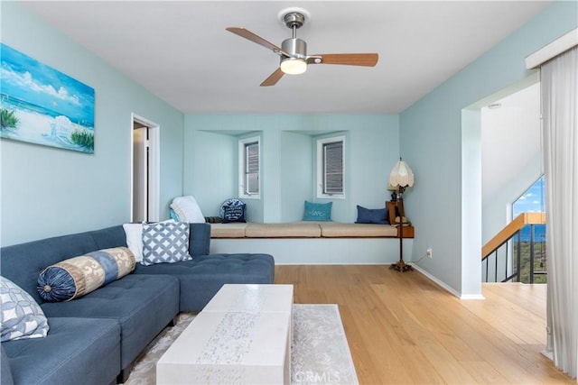 living room featuring light wood-type flooring and ceiling fan