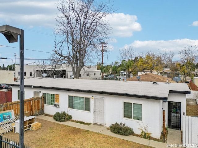 view of front of home with cooling unit and a front lawn