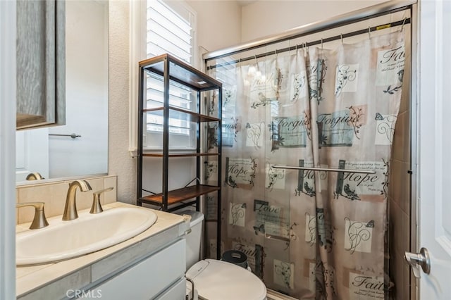 bathroom with vanity, curtained shower, and toilet