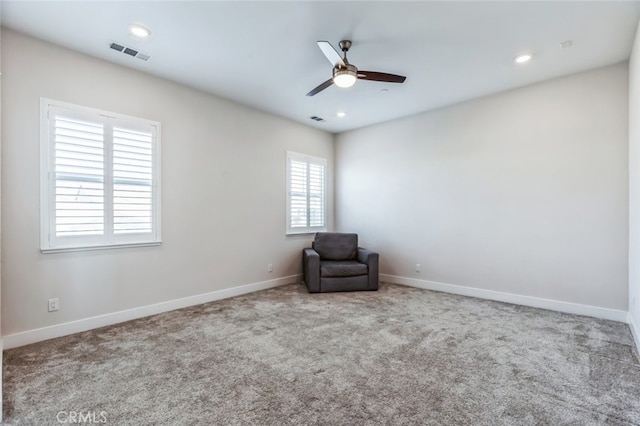 unfurnished room with light colored carpet and ceiling fan