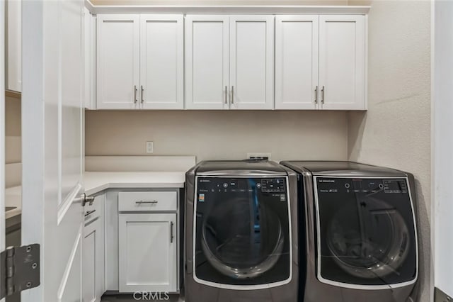 laundry room with cabinets and washer and clothes dryer