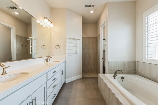 bathroom featuring tile patterned flooring, vanity, separate shower and tub, and a healthy amount of sunlight