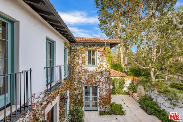 view of side of property with a patio area